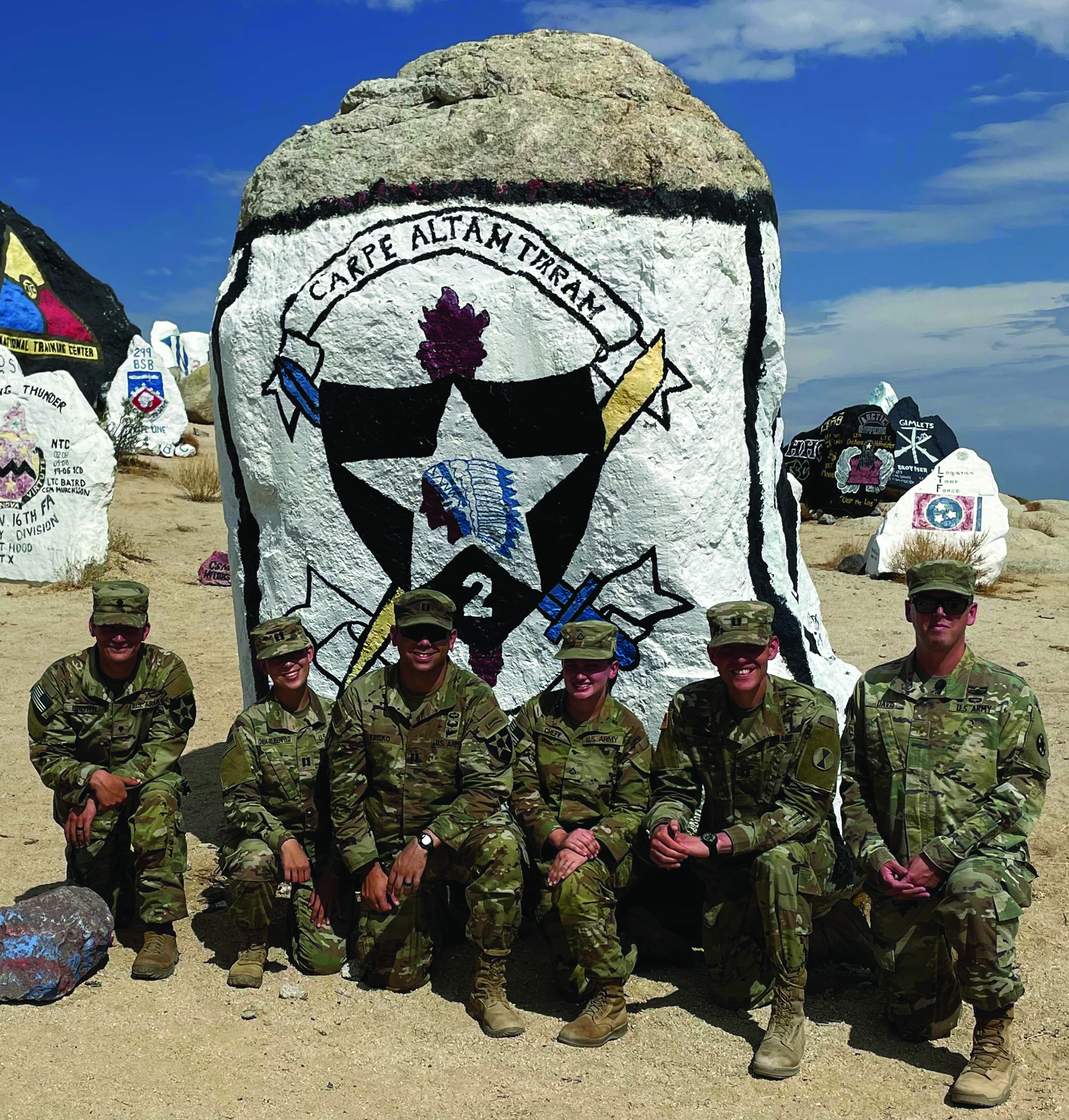 Members of 2-2 Stryker Brigade Combat Team and 7th Infantry Division work hard at the National Training Center Rotation 21-09. 2-2’s rotation was the 400th unit to go through NTC. The team photo in front of the 2-2 painted rock features (L to R): SPC Zachary Brown, CPT Sophia Chua-Rubenfeld, CPT Jonathon Krisko, PFC Taylor Cheff, CPT Shawn Delancey, and MAJ Timothy Davis (OC/T).